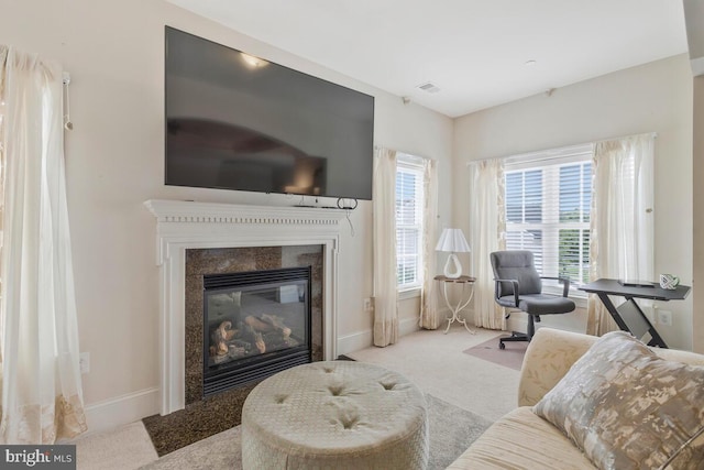 living room with carpet flooring and a premium fireplace