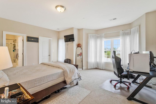 carpeted bedroom featuring connected bathroom