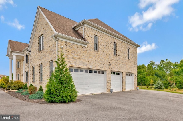 view of side of property with a garage