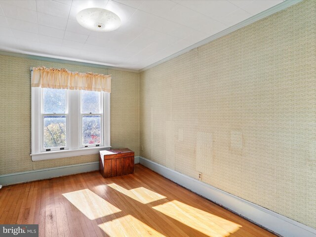 interior space with dark tile patterned flooring and ornamental molding