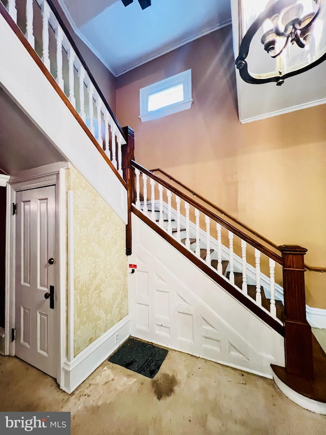 stairs with concrete flooring and a high ceiling