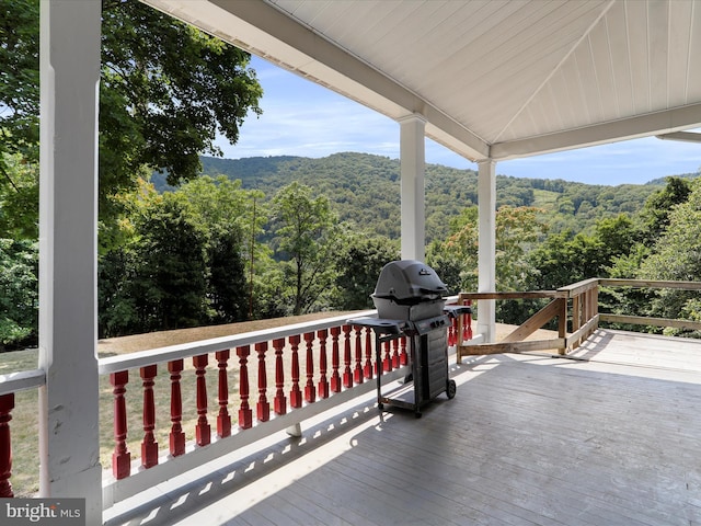 wooden deck with a grill and a mountain view