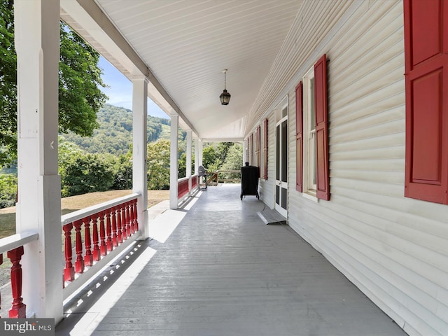 deck featuring a porch and a mountain view