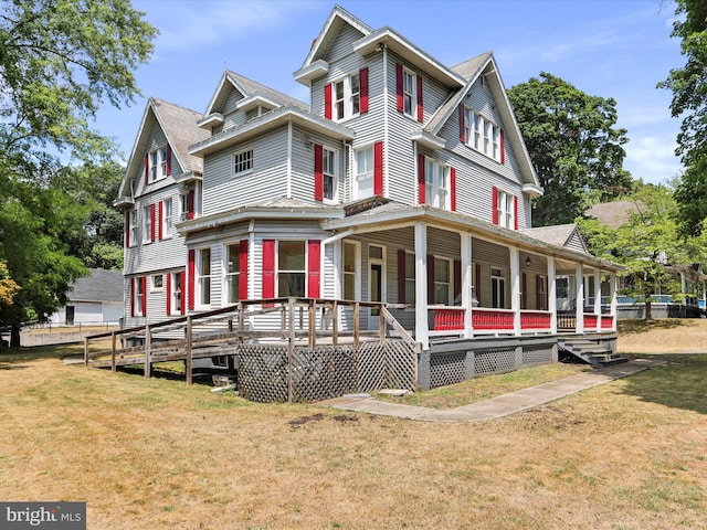 victorian house with a porch and a front yard