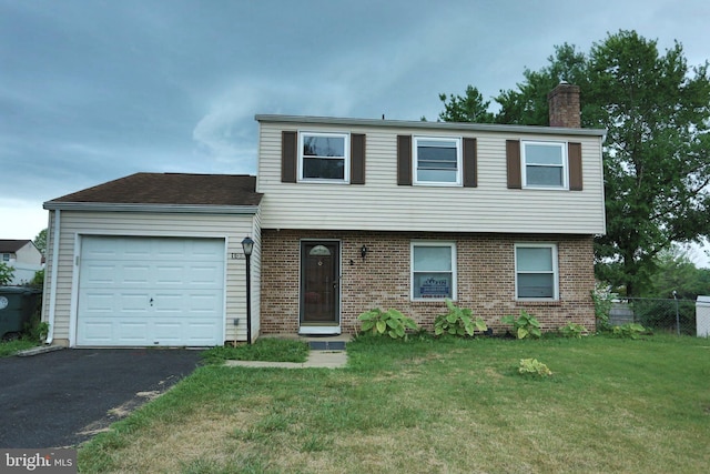 view of front of property with a garage and a front lawn