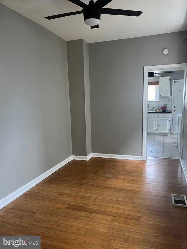 tiled spare room with ceiling fan