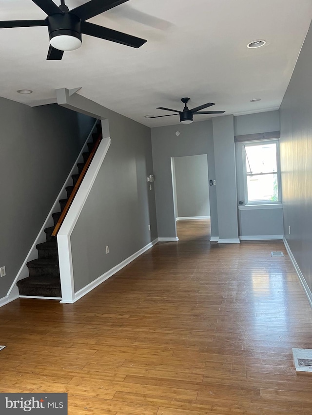 empty room with ceiling fan and light wood-type flooring