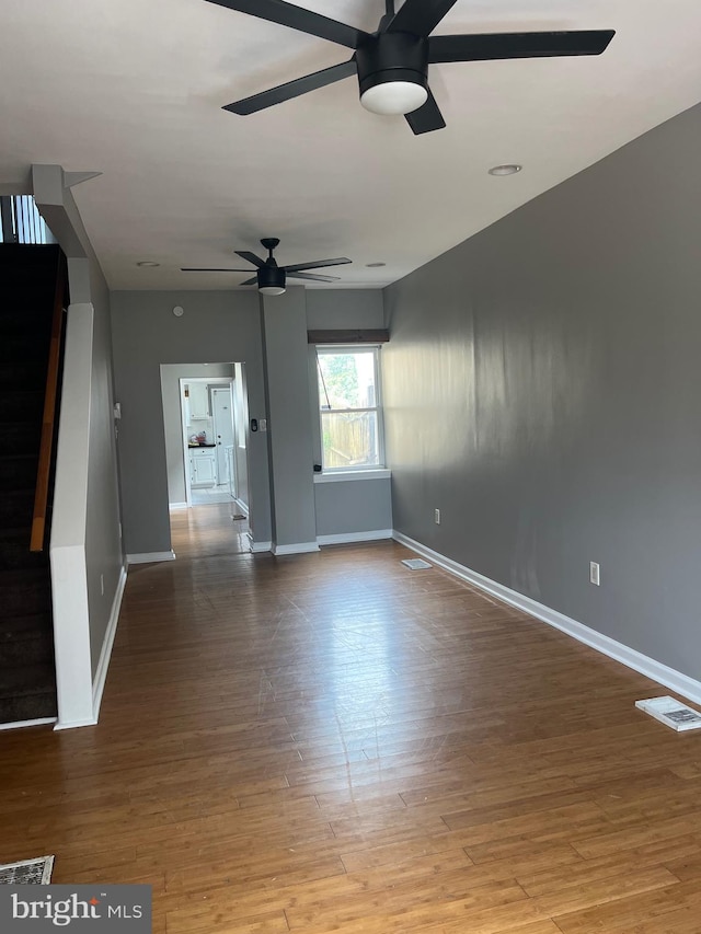 interior space with wood-type flooring and ceiling fan