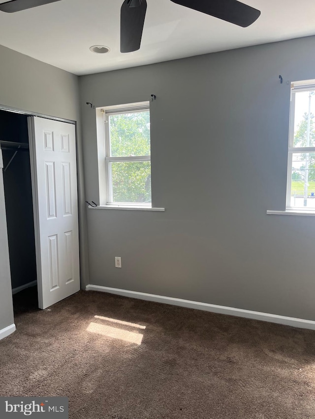 unfurnished bedroom featuring a closet, carpet, and ceiling fan