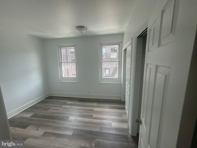 unfurnished room with dark hardwood / wood-style floors