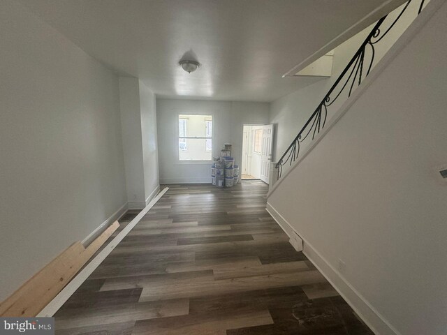 corridor with hardwood / wood-style floors