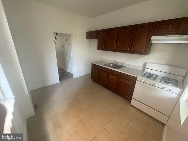 kitchen featuring white gas range and sink