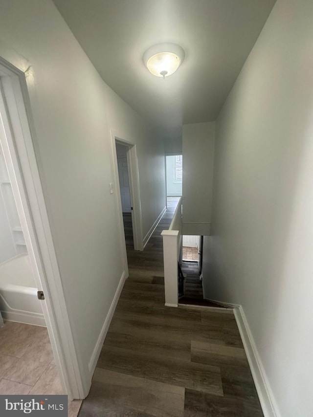 hallway with dark wood-type flooring