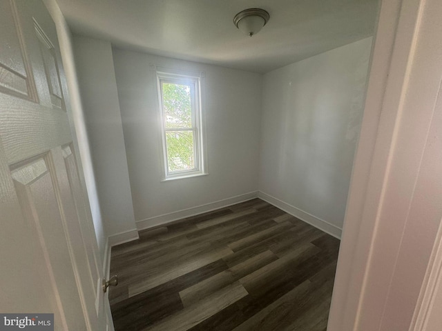 spare room featuring dark wood-type flooring