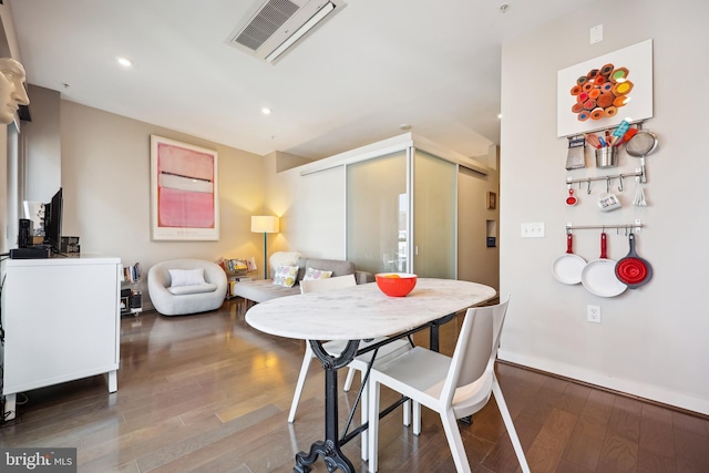 dining area with hardwood / wood-style floors