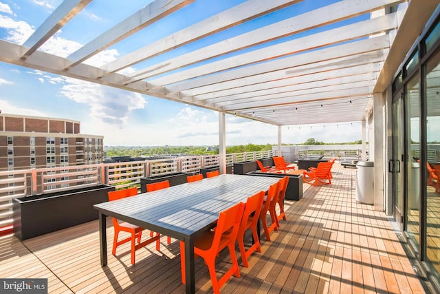 wooden terrace with a pergola and an outdoor living space with a fire pit