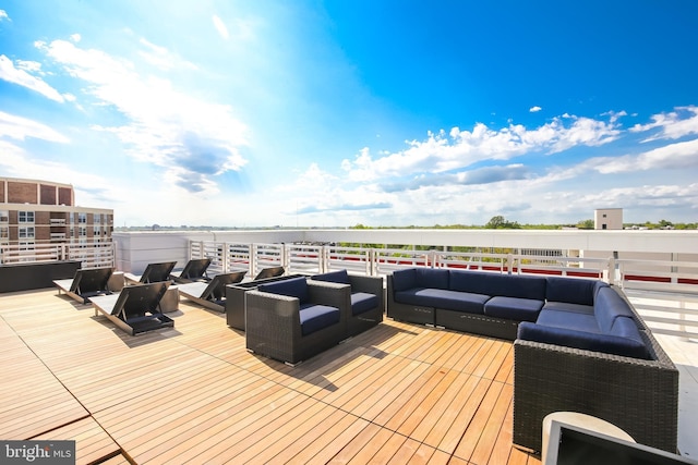 wooden terrace with an outdoor living space