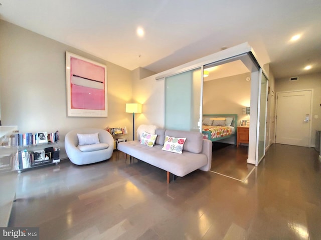 living room with wood-type flooring and a barn door