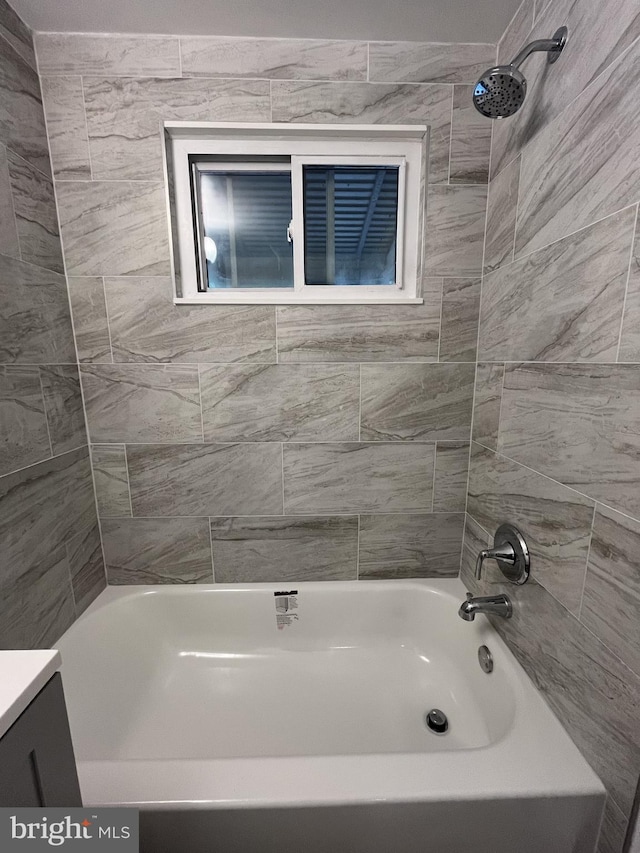 bathroom with vanity and tiled shower / bath