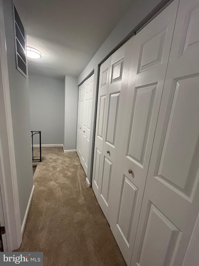 hallway featuring carpet flooring