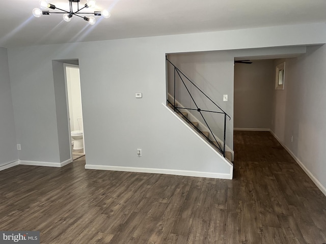 interior space featuring dark wood-type flooring, baseboards, and stairs