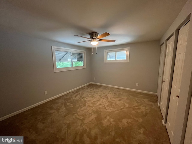 unfurnished bedroom with ceiling fan and carpet floors