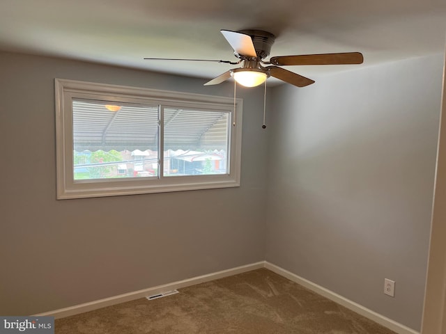 spare room featuring carpet flooring and ceiling fan