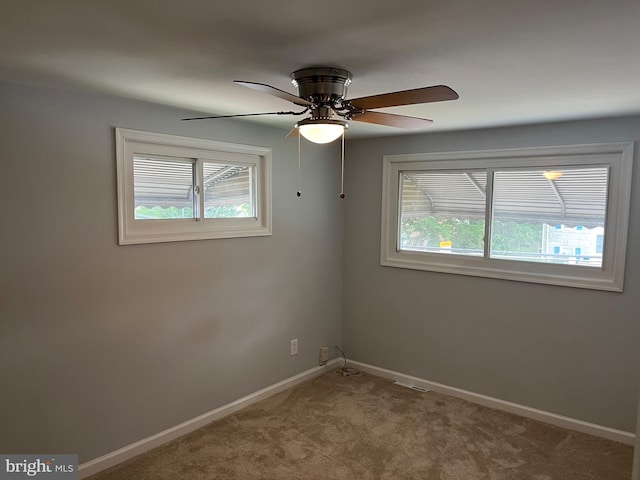 unfurnished room with ceiling fan and carpet flooring