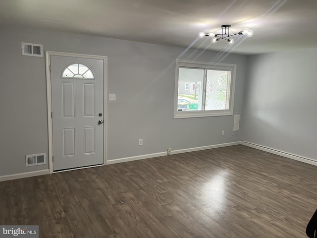 entryway featuring dark hardwood / wood-style flooring and a chandelier