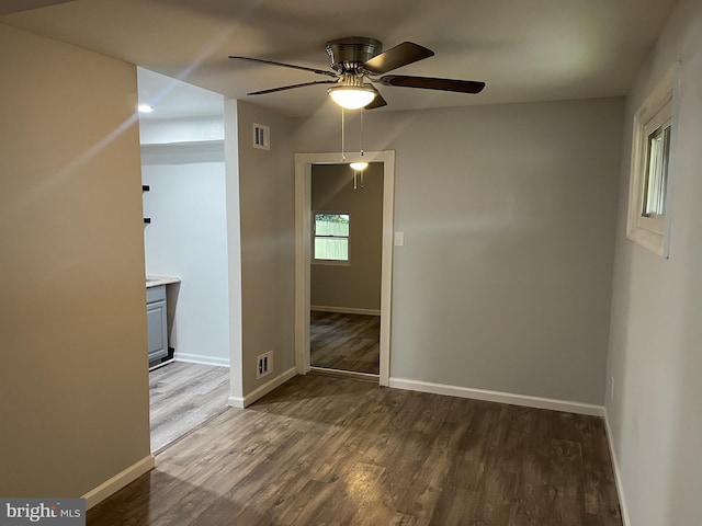 spare room with ceiling fan and dark hardwood / wood-style flooring