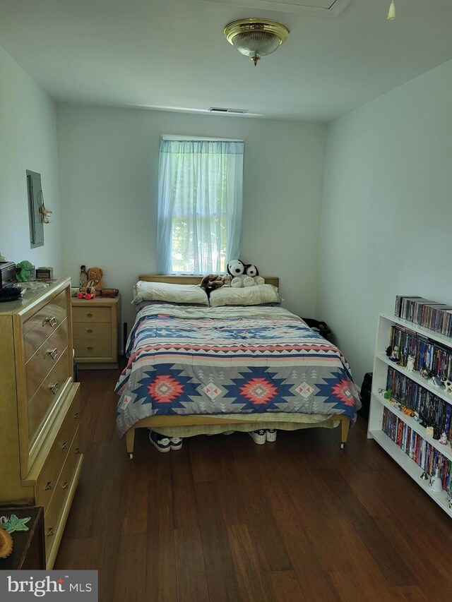 bedroom with dark wood-type flooring