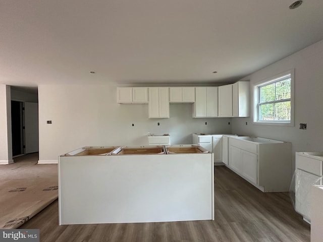 kitchen featuring white cabinetry, a kitchen island, and light hardwood / wood-style floors