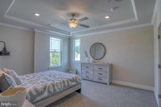 bedroom featuring ornamental molding, light carpet, ceiling fan, and a raised ceiling