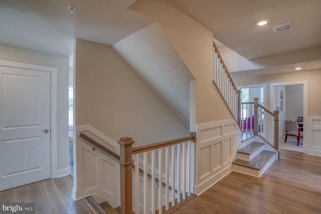 interior space with stairs, visible vents, recessed lighting, light wood-type flooring, and wainscoting