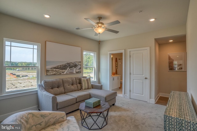 living room with light colored carpet and ceiling fan