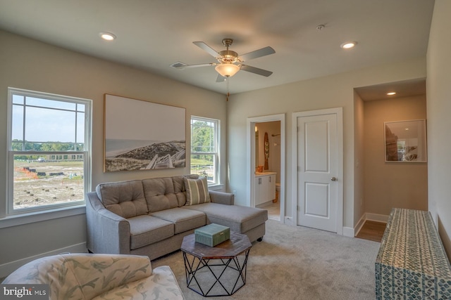 carpeted living area featuring baseboards, ceiling fan, and recessed lighting