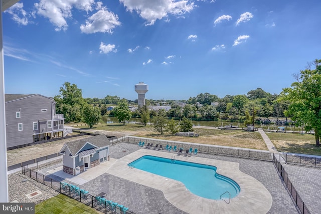 view of pool featuring a lawn and a patio area