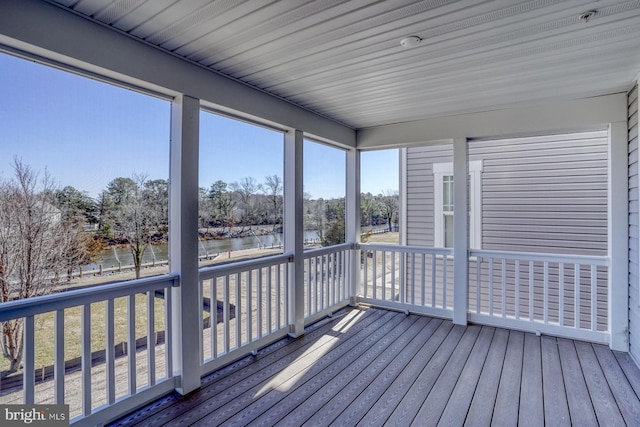 unfurnished sunroom with a water view