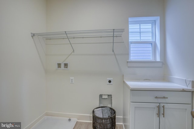 laundry area featuring hookup for a washing machine, baseboards, cabinet space, and electric dryer hookup