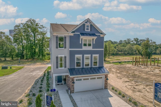 view of front of home with metal roof, concrete driveway, board and batten siding, a standing seam roof, and a garage