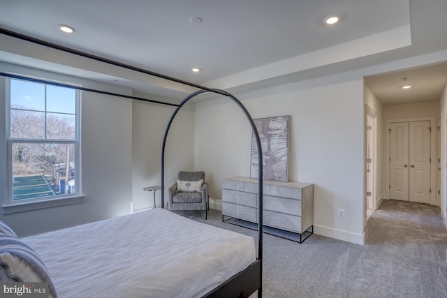 bedroom featuring baseboards, light carpet, and recessed lighting