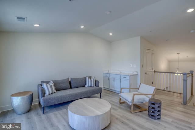 living area with light wood-style flooring, visible vents, lofted ceiling, and recessed lighting