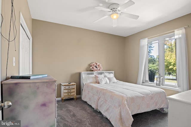 bedroom with a ceiling fan, carpet, and baseboards