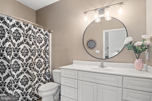 bathroom with toilet and vanity