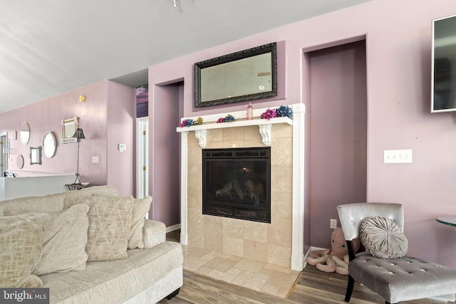 living room featuring wood finished floors and a tile fireplace