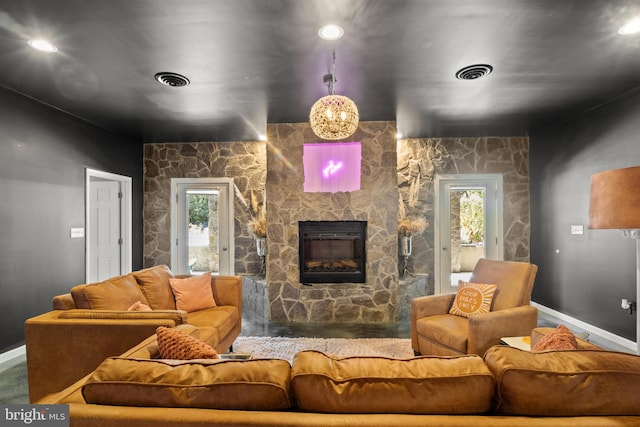 living room with a stone fireplace