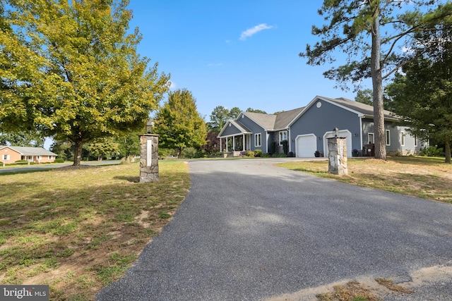 ranch-style house with a garage and a front yard