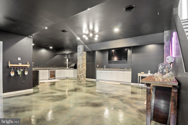 interior space with beverage cooler, visible vents, and a sink