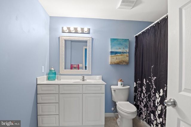 bathroom featuring tile patterned floors, toilet, and vanity