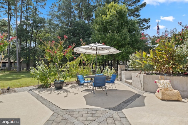 view of patio with outdoor dining space and fence